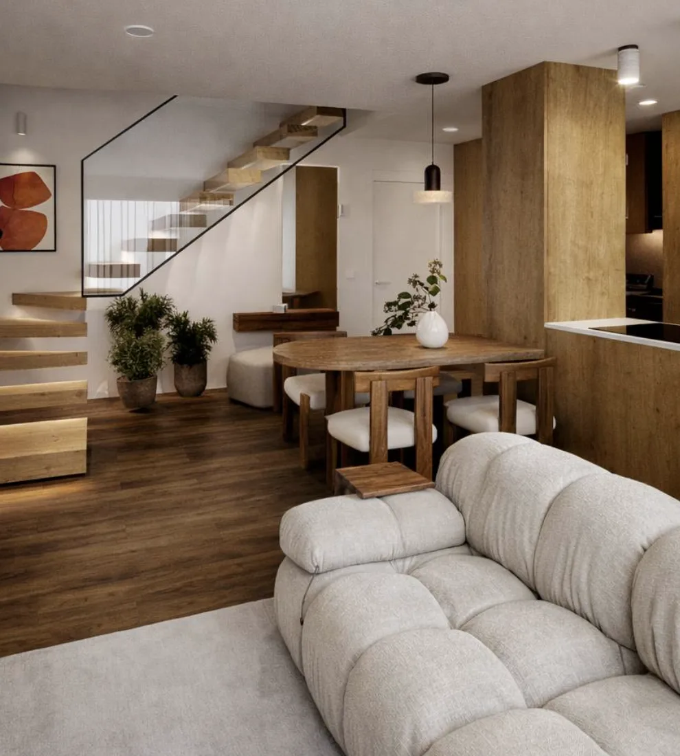 Room with a light sofa, dining table, and wooden stairs, integrated with the kitchen