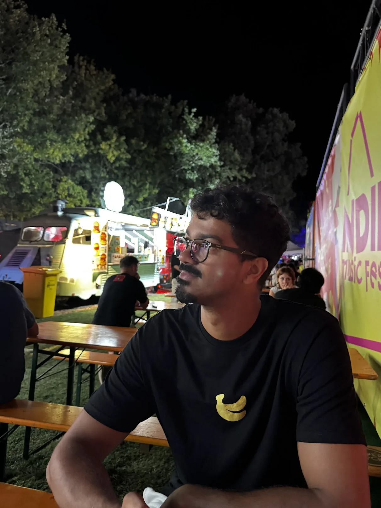 Leo sitting in the Indie Music Fest food area at night
