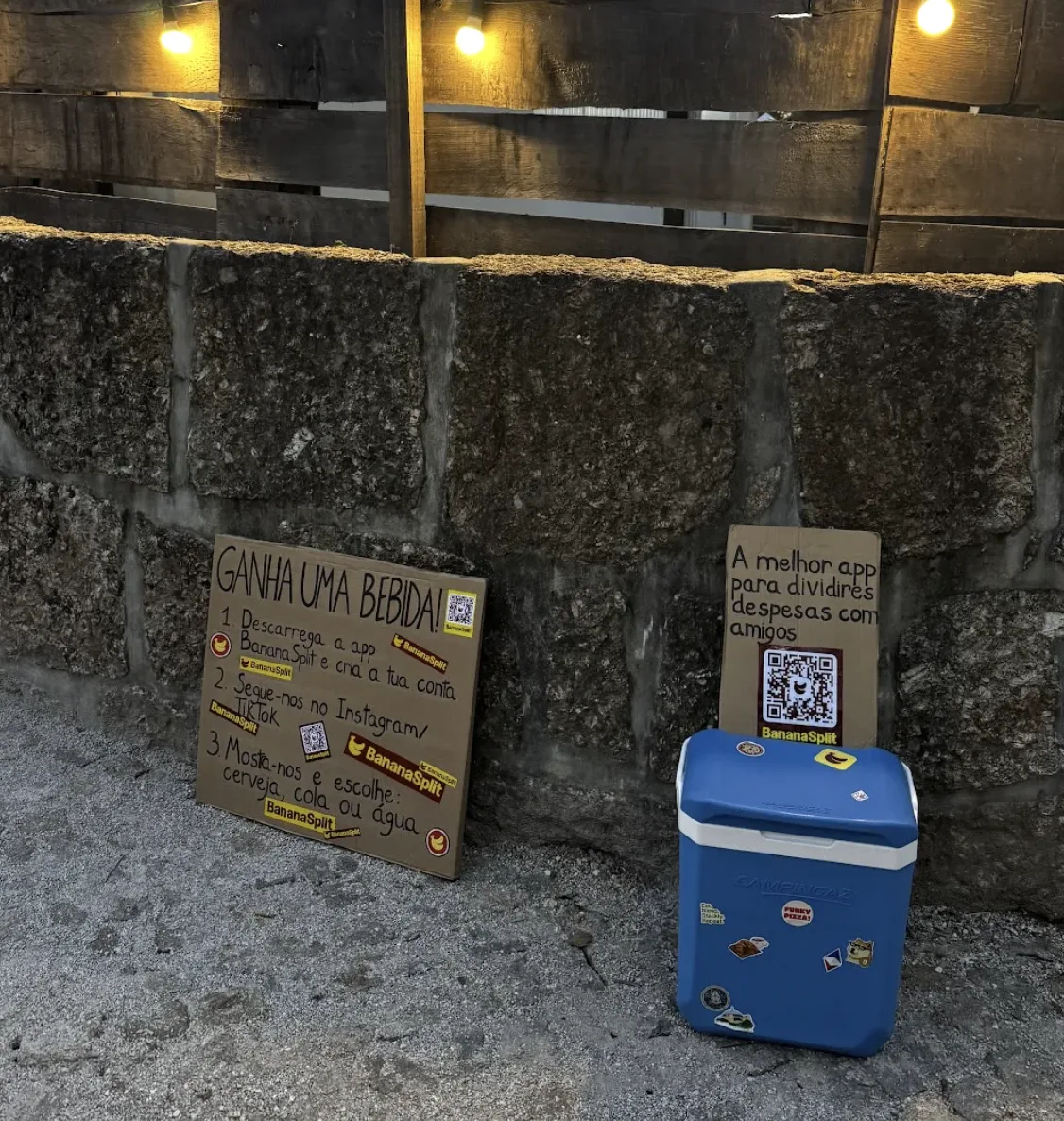Blue cooler and two BananaSplit posters leaning against the wall by the festival entrance