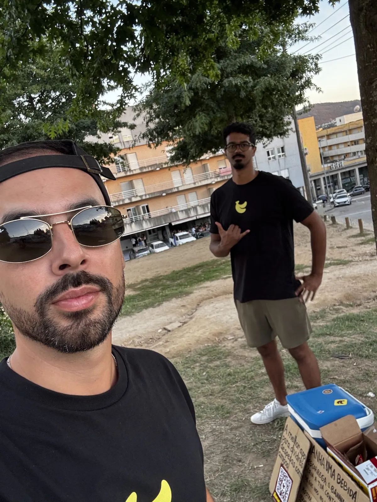 Selfie of two BananaSplit team members at the end of the first afternoon of campaigning, with the cooler and the sign box beside them