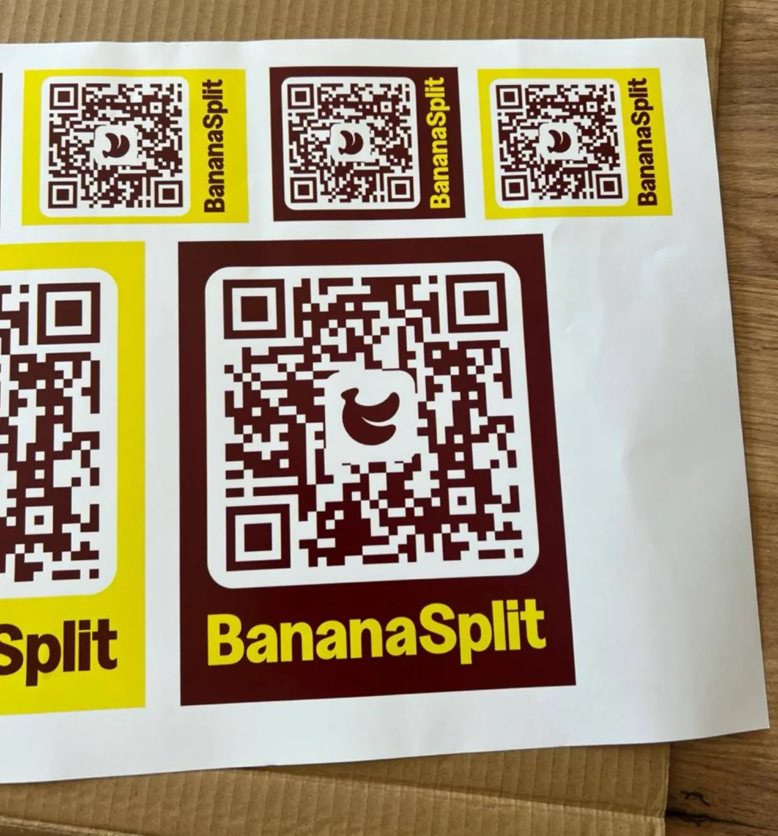 Printed BananaSplit QR code sticker proofs in brown and yellow colourways